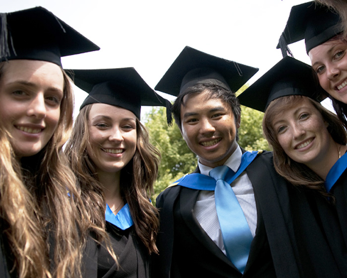 A group of students dressed in their graduation robes