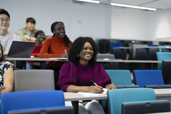 student smiling in a lecture room