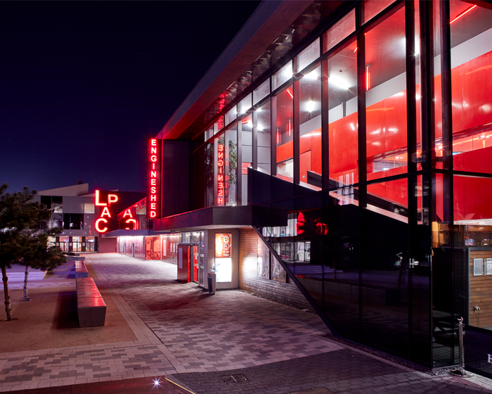 Exterior of the Engine Shed at night, with the 澳门赛马会 Arts Centre in the background